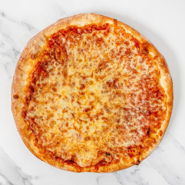 Round cheese pizza with golden crust and melted mozzarella on a white marble surface.